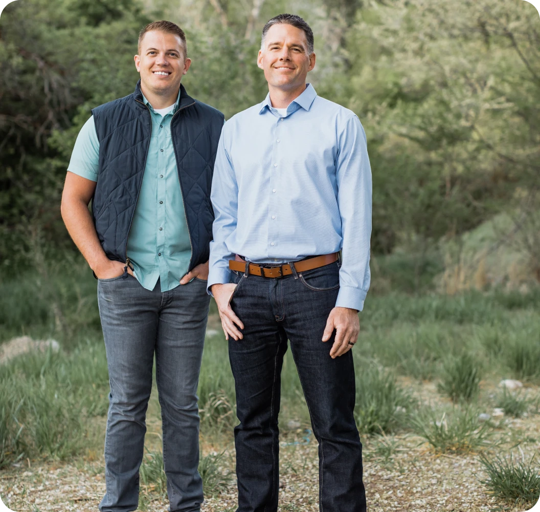Founders Shane Rowley and Dave Olsen standing in front of a woodland backdrop.