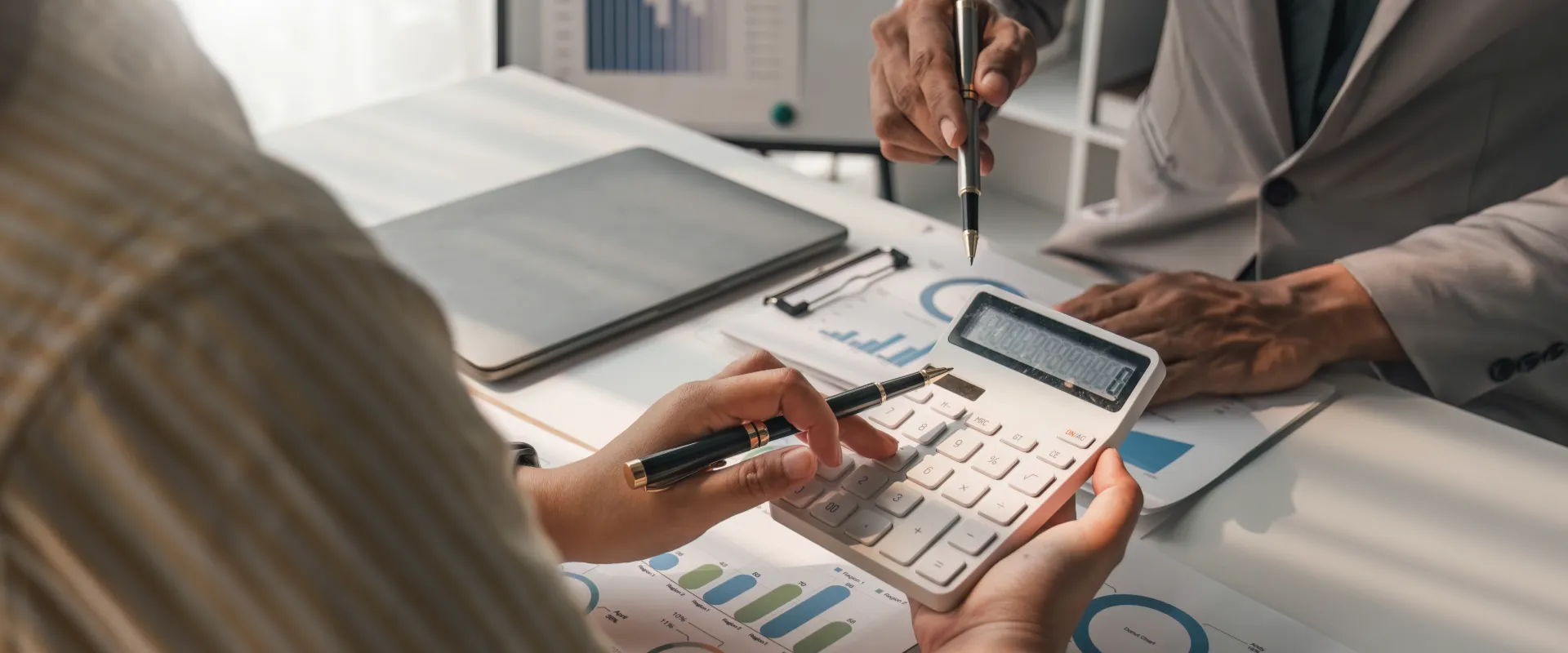 Two business people talk strategy at an office.