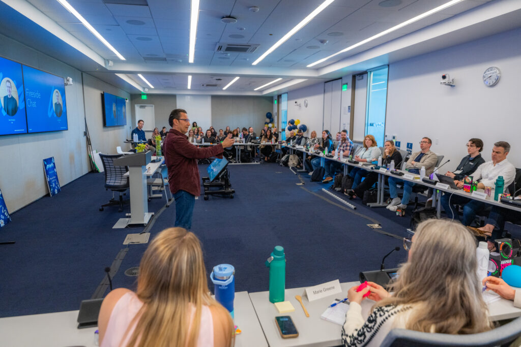 The Intuit Partner Council discusses business in a meeting room.