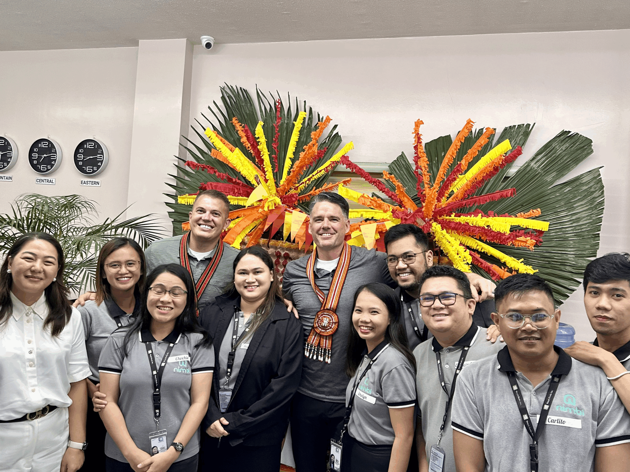 Founders Dave Olsen and Shane Rowley pose for a photo with members of the Philippines team.