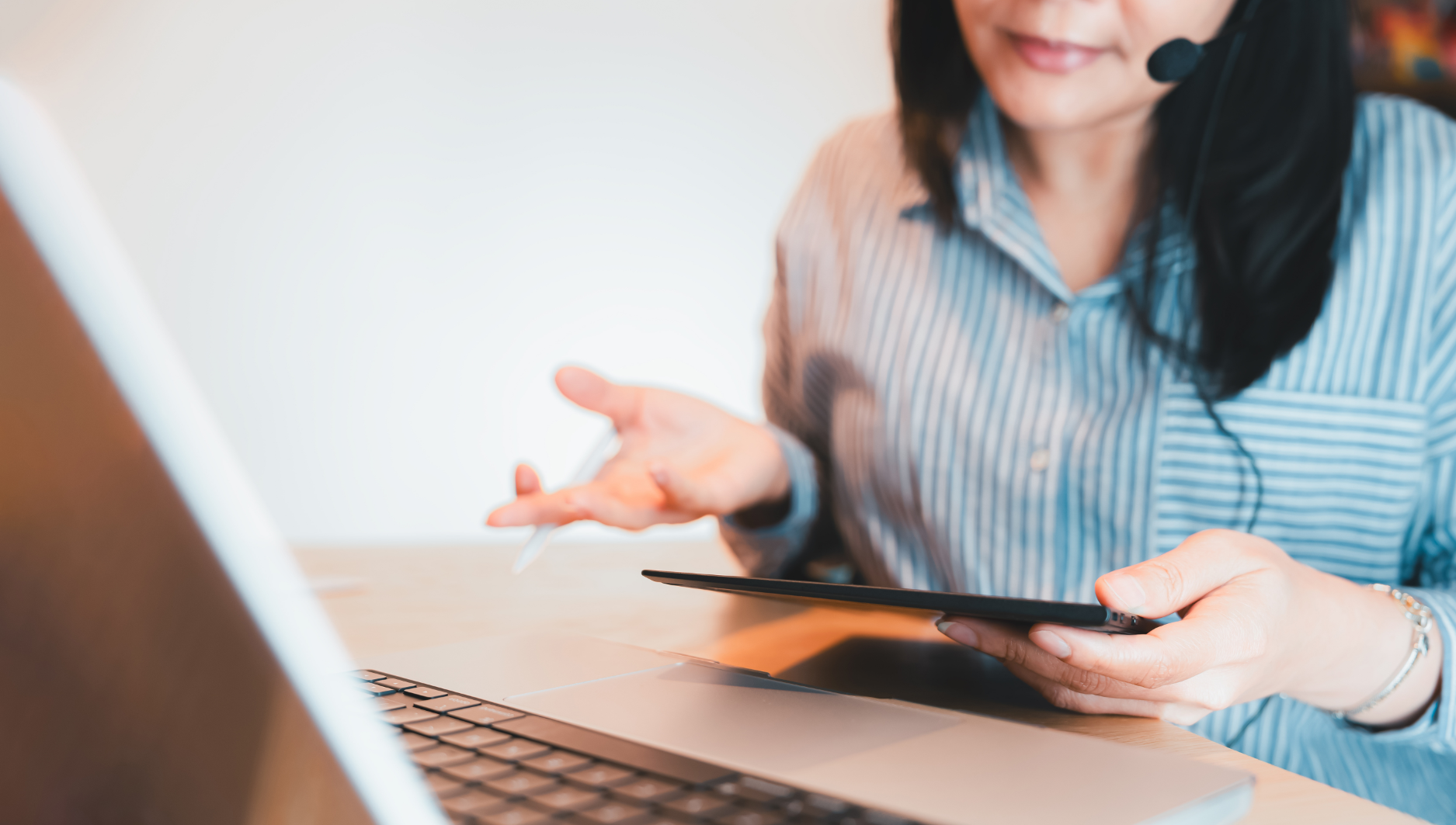 Remote team member assists a client on a virtual call in an office.